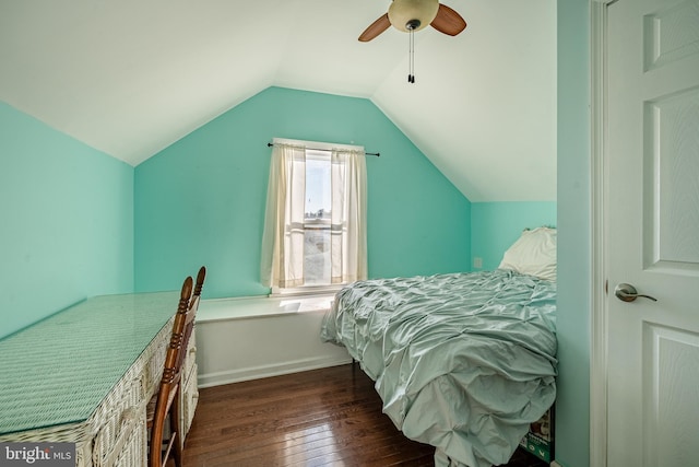 bedroom featuring ceiling fan, dark hardwood / wood-style floors, and vaulted ceiling