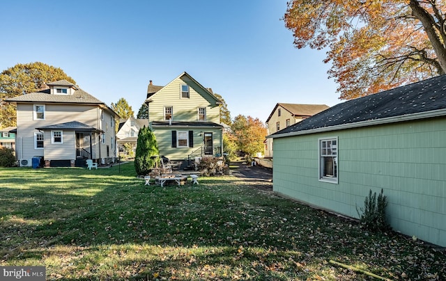 back of property featuring a yard