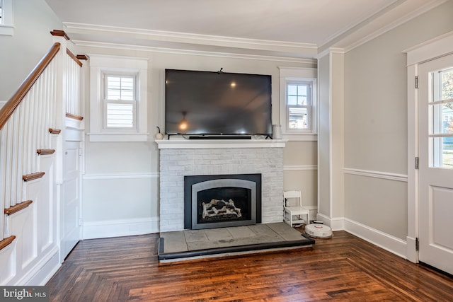 unfurnished living room featuring ornamental molding, a fireplace, and a wealth of natural light