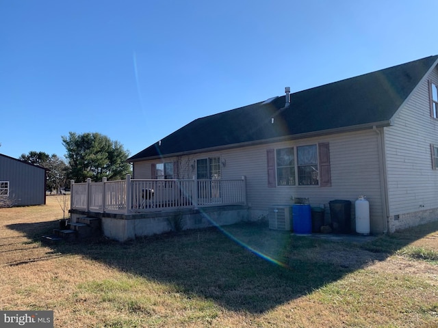 back of house with a lawn, a wooden deck, and cooling unit