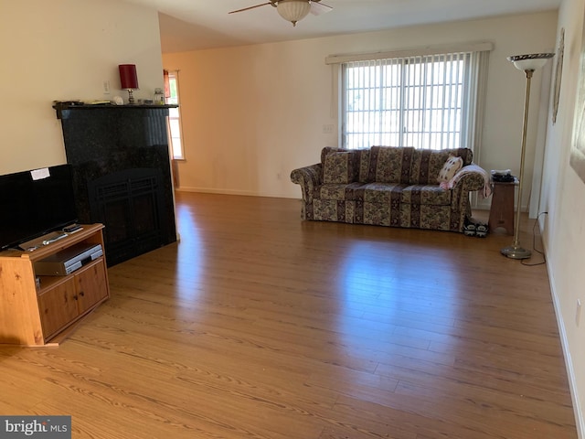 living room featuring ceiling fan and light hardwood / wood-style flooring