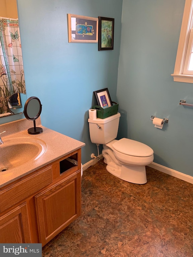 bathroom featuring vanity and toilet