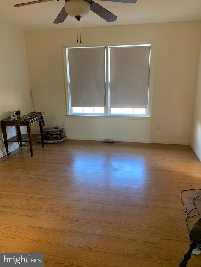 empty room with light hardwood / wood-style floors and ceiling fan