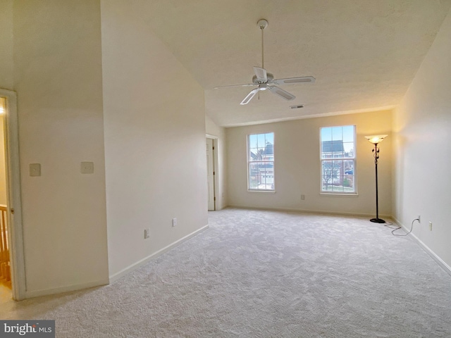 empty room with light carpet, lofted ceiling, and ceiling fan