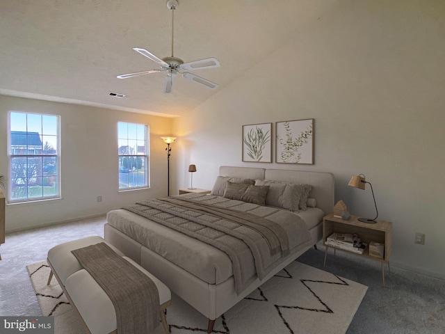 bedroom with ceiling fan, lofted ceiling, and light carpet