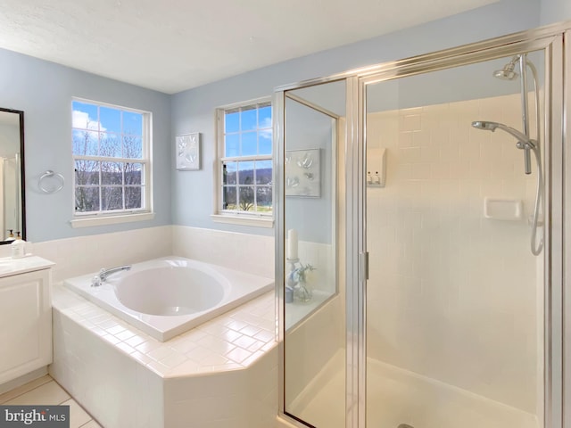 bathroom featuring shower with separate bathtub, tile patterned floors, and vanity