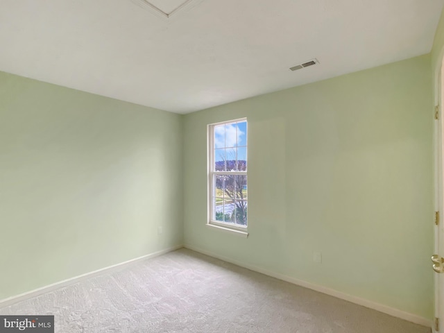 spare room with light colored carpet