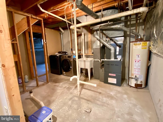 basement with heating unit, sink, gas water heater, and washing machine and clothes dryer