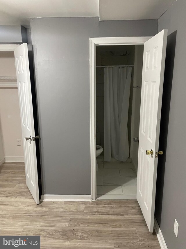 unfurnished bedroom with a closet and light hardwood / wood-style flooring