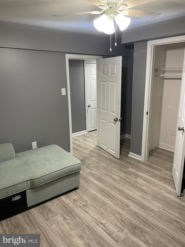 bedroom featuring a closet, ceiling fan, and light hardwood / wood-style flooring