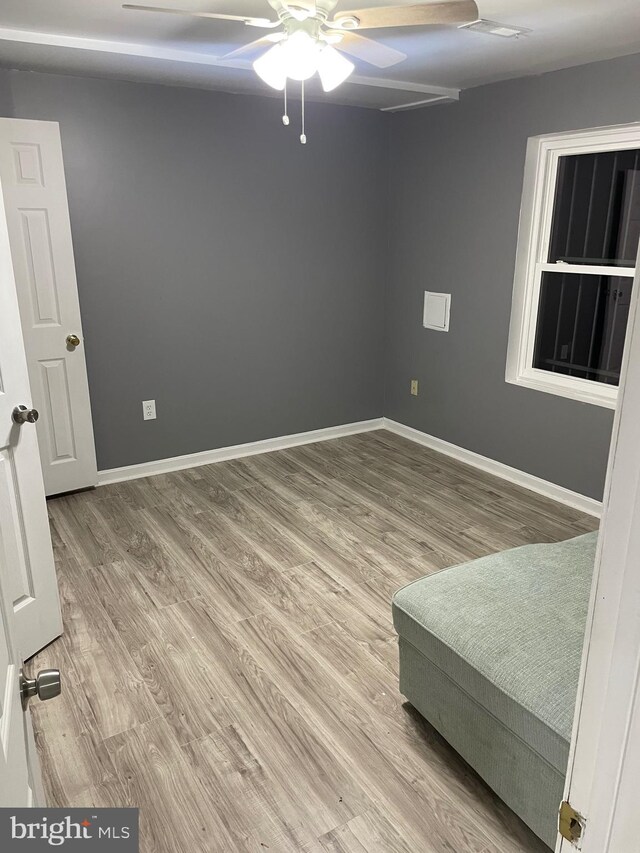 unfurnished room with ceiling fan and wood-type flooring