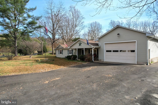 single story home featuring a garage and a front lawn