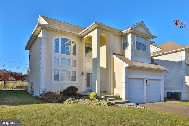 view of front of property featuring a front lawn and a garage