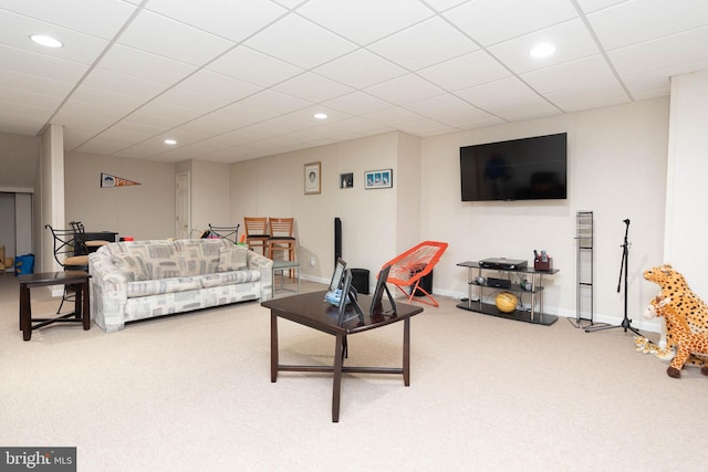 carpeted living room with a paneled ceiling