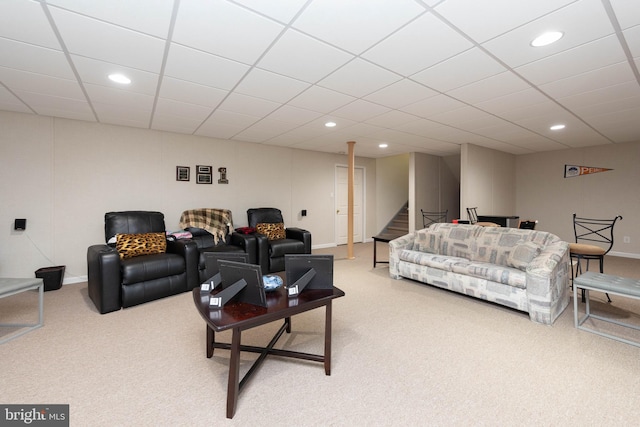 living room with carpet flooring and a paneled ceiling