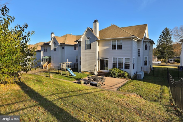 rear view of property featuring a yard, a patio, and central AC unit