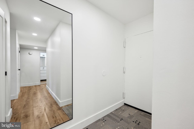 corridor with light wood-type flooring