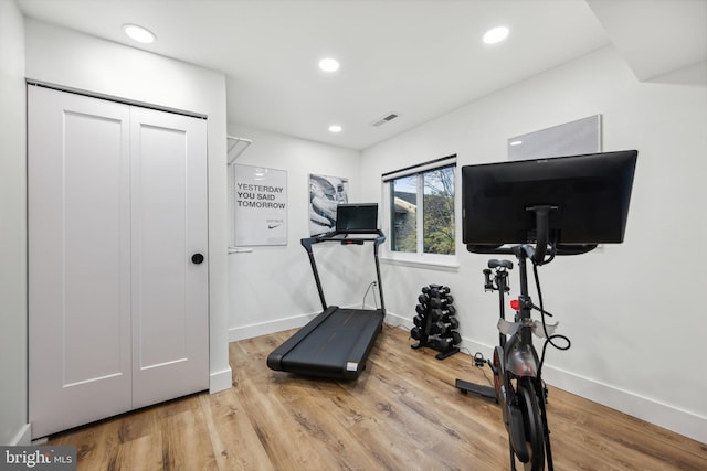 workout area with hardwood / wood-style floors