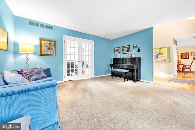 living area with carpet flooring and french doors