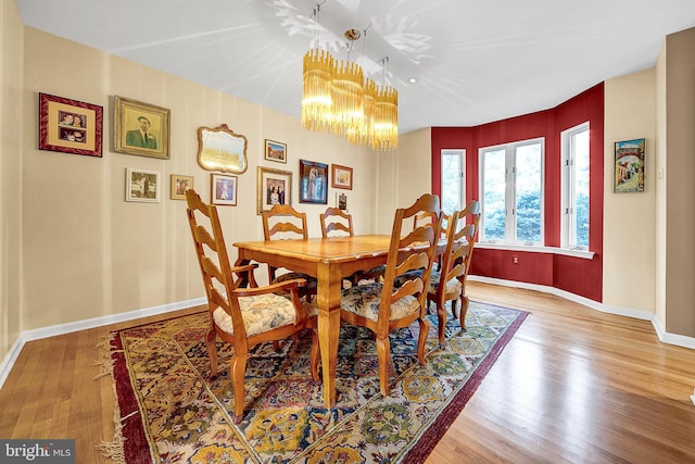 dining room with a notable chandelier and hardwood / wood-style flooring