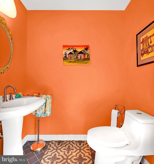 bathroom with tile patterned floors and toilet