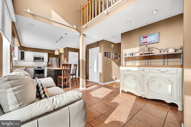 living room featuring tile patterned flooring and a high ceiling