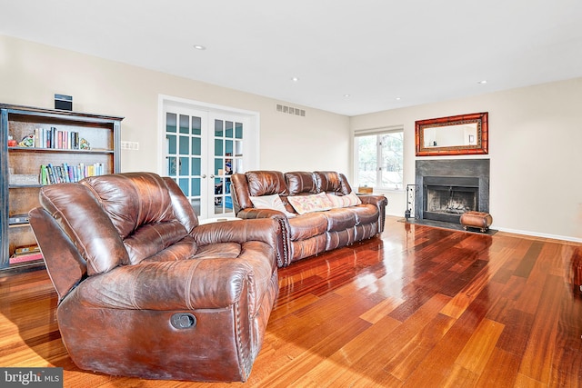 living room featuring french doors and light hardwood / wood-style flooring