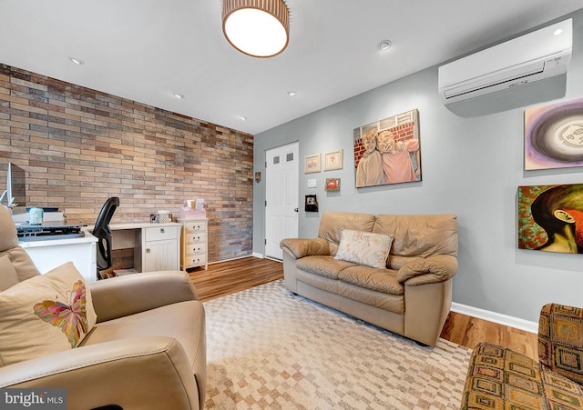 living room with an AC wall unit, brick wall, and light wood-type flooring