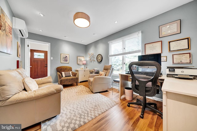 office area featuring light hardwood / wood-style floors and an AC wall unit