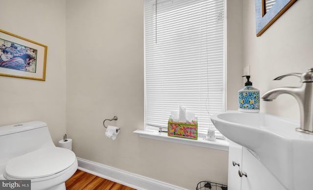 bathroom featuring hardwood / wood-style floors, vanity, and toilet