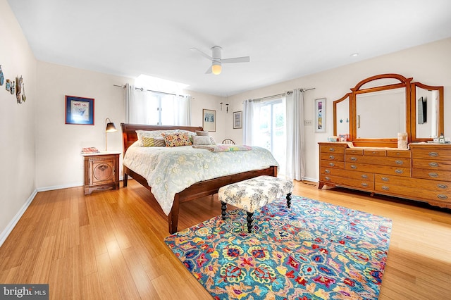 bedroom with light hardwood / wood-style flooring and ceiling fan