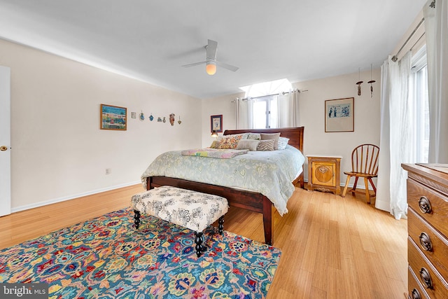 bedroom with light hardwood / wood-style floors, multiple windows, and ceiling fan