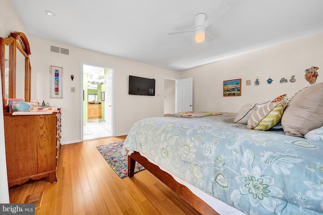 bedroom with connected bathroom, light hardwood / wood-style floors, and ceiling fan