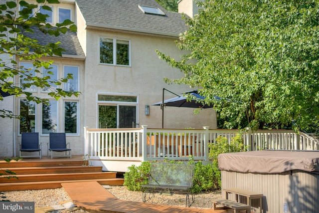 back of house featuring a deck