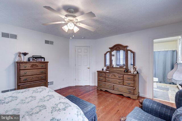 310 Updyke Rd, Littlestown, PA 17340 - bedroom with wood finished floors, baseboards, ceiling fan, and ensuite bathroom