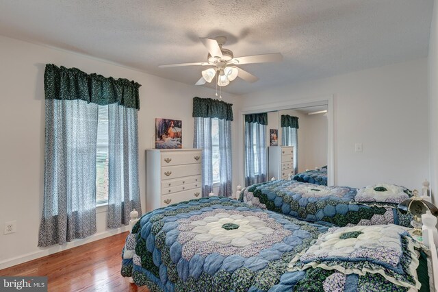 310 Updyke Rd, Littlestown, PA 17340 - bedroom featuring wood finished floors, baseboards, a textured ceiling, ceiling fan, and a closet