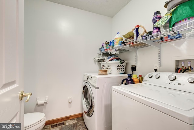 310 Updyke Rd, Littlestown, PA 17340 - washroom featuring separate washer and dryer, baseboards, and stone finish floors