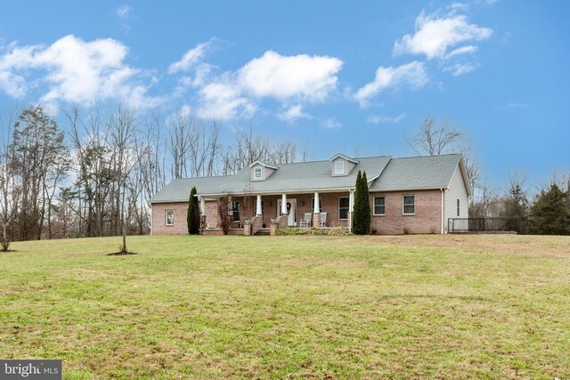 310 Updyke Rd, Littlestown, PA 17340 - view of front of house with covered porch, brick siding, and a front lawn