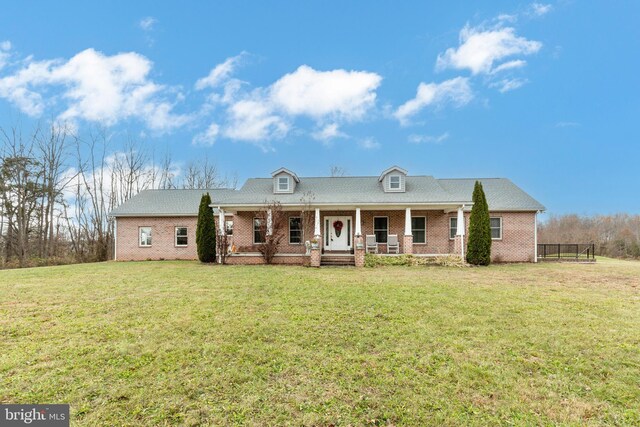 310 Updyke Rd, Littlestown, PA 17340 - view of front of property with covered porch, a front lawn, and brick siding