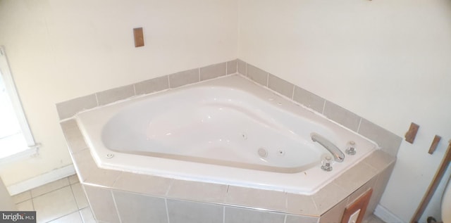 bathroom with tiled bath and tile patterned flooring