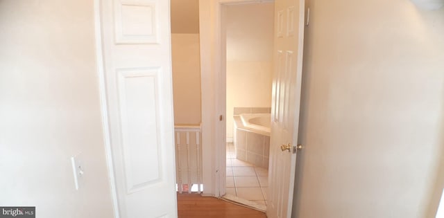 hallway with hardwood / wood-style floors