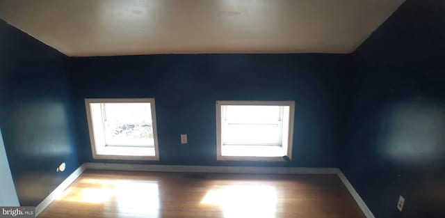 unfurnished room with hardwood / wood-style floors