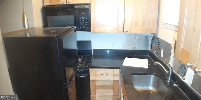 kitchen with decorative backsplash, sink, dark stone countertops, and black appliances