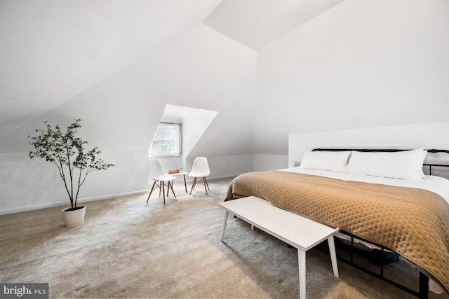 bedroom with carpet and lofted ceiling