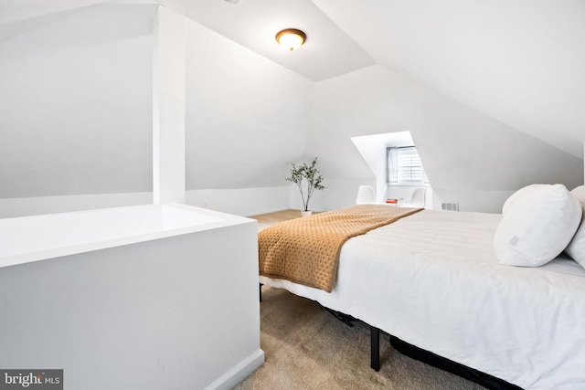 bedroom with light carpet and vaulted ceiling