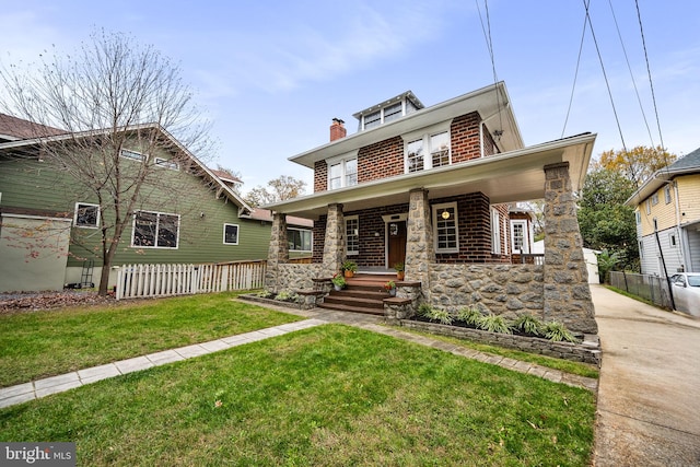 view of front of property with a front yard and a porch