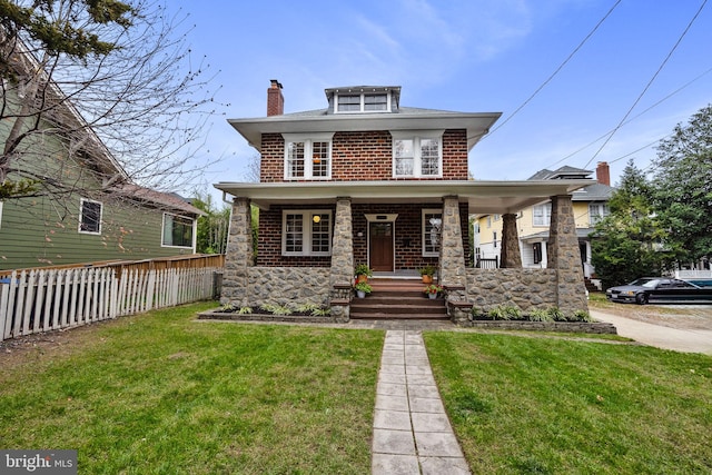 view of front of home with a front lawn and covered porch