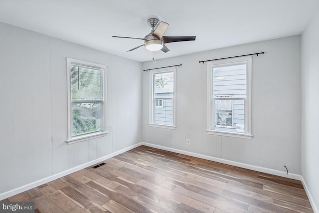 empty room with hardwood / wood-style flooring and ceiling fan