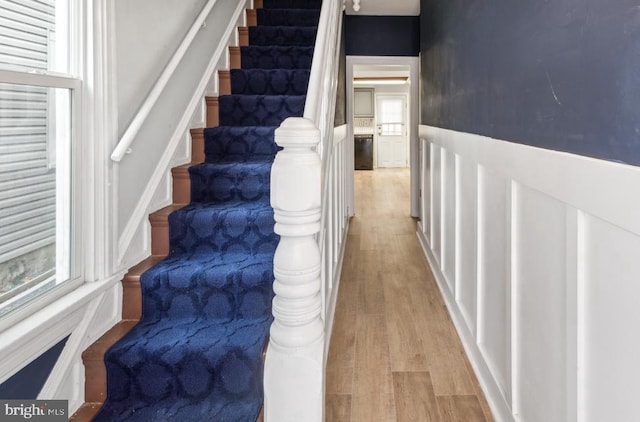 stairs featuring wood-type flooring