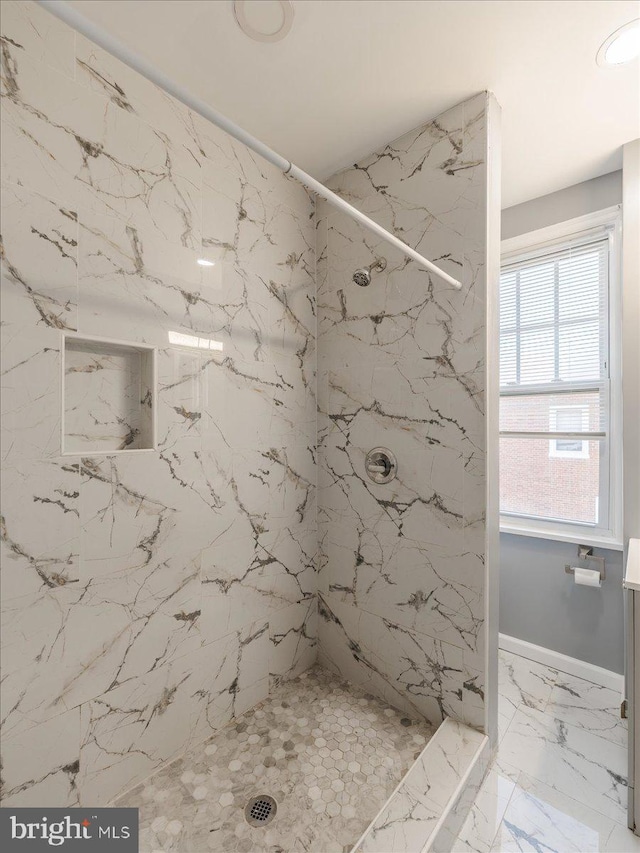 bathroom featuring a tile shower